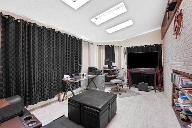 office space with vaulted ceiling and light wood-style floors