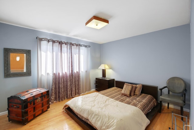 bedroom featuring light wood-type flooring and baseboards