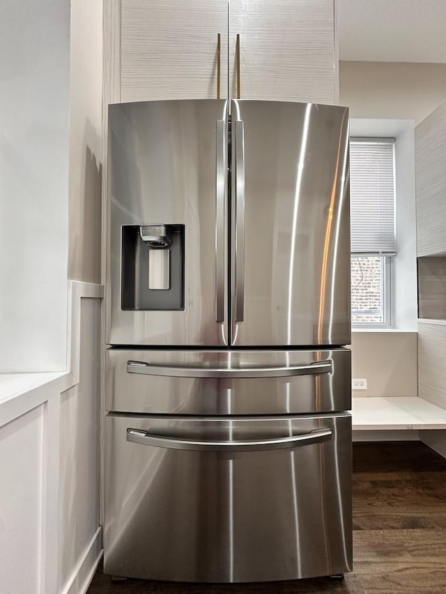 details with stainless steel fridge and dark wood-type flooring