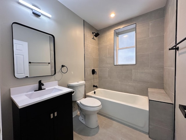 full bathroom featuring toilet, vanity, and tiled shower / bath combo