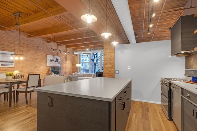 kitchen featuring double oven range, brick wall, a center island, and wood ceiling