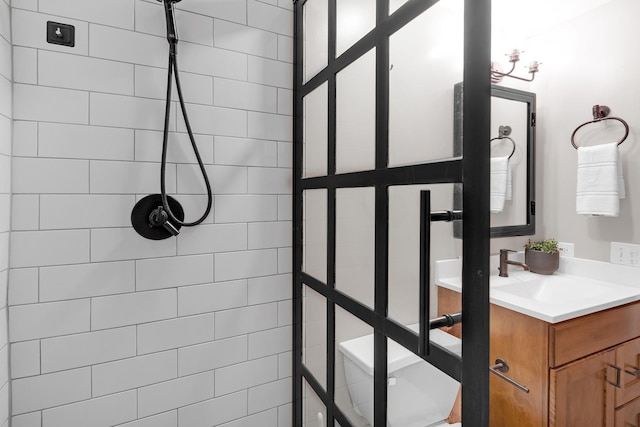 bathroom with vanity and a tile shower