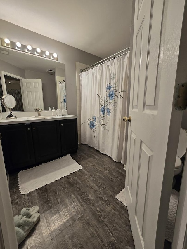 bathroom with hardwood / wood-style flooring and vanity