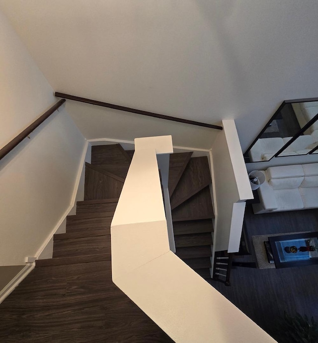 staircase with hardwood / wood-style floors