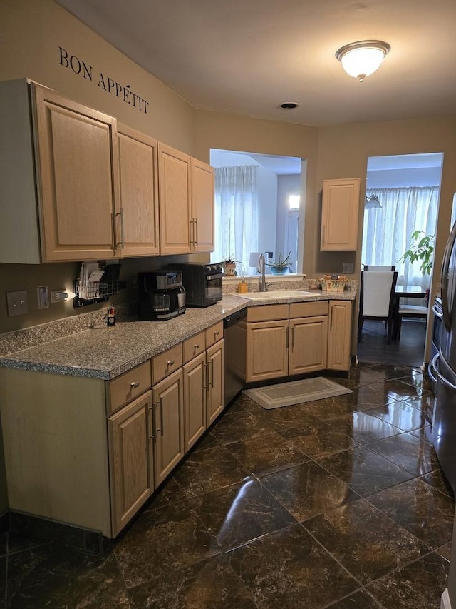 kitchen with sink, light brown cabinets, and stainless steel dishwasher