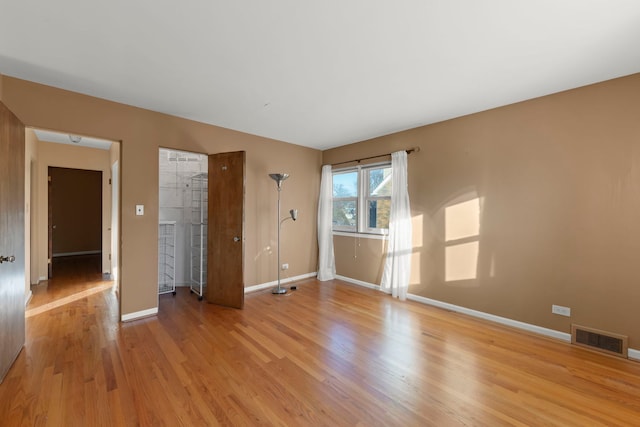 empty room with light hardwood / wood-style floors