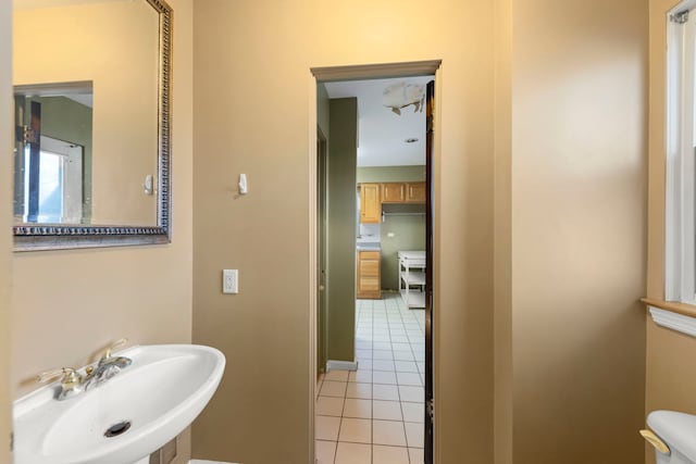 bathroom featuring toilet, tile patterned floors, and sink