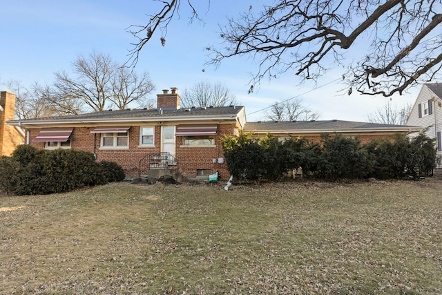 rear view of house with a lawn