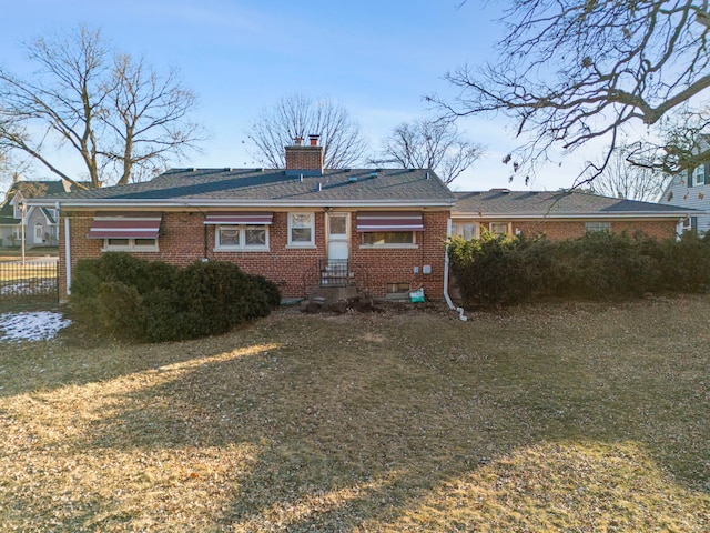 rear view of property with a yard