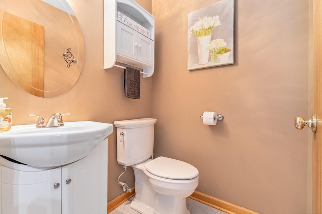 bathroom featuring toilet and vanity