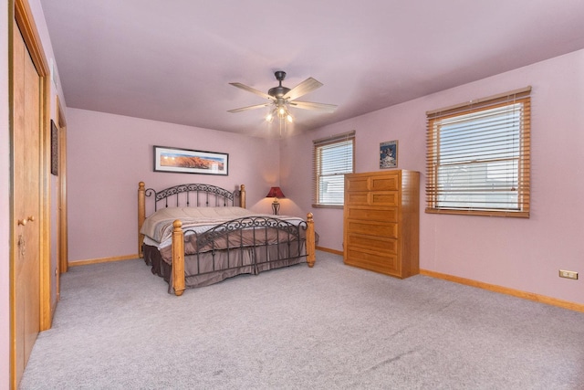 carpeted bedroom featuring a closet and ceiling fan