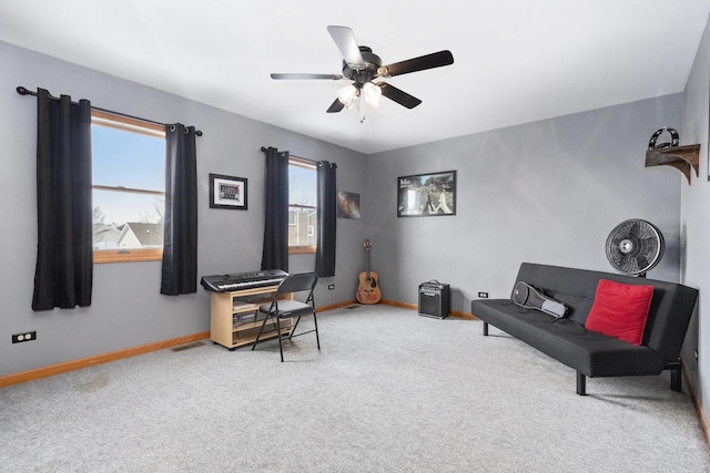 sitting room featuring a wealth of natural light, ceiling fan, and carpet floors