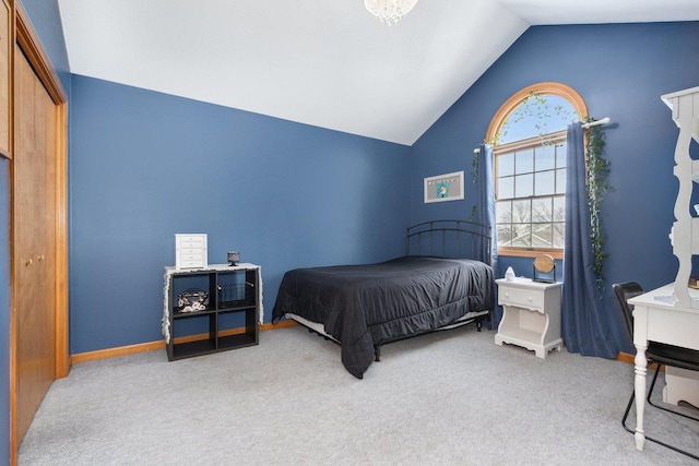 bedroom featuring light colored carpet and vaulted ceiling