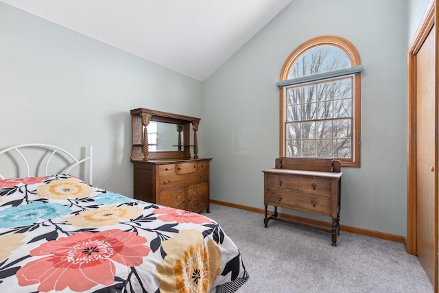 bedroom with light carpet, vaulted ceiling, a closet, and multiple windows