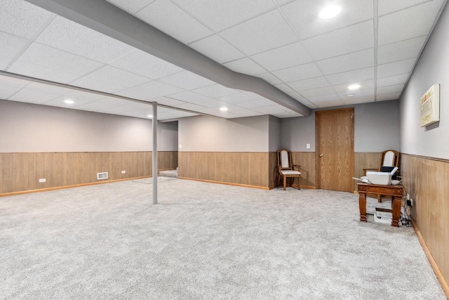 basement featuring light colored carpet