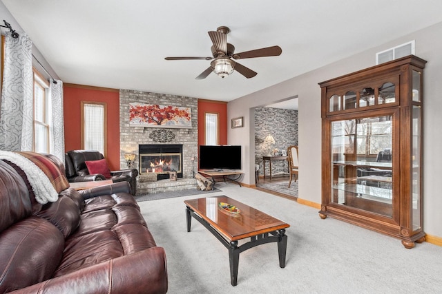 living room featuring ceiling fan, carpet flooring, and a fireplace