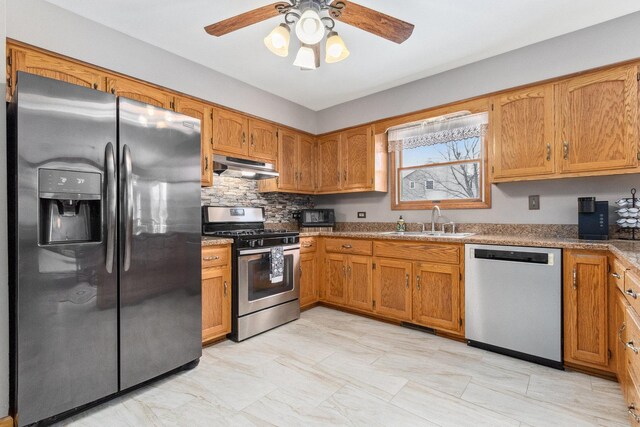 kitchen with stainless steel appliances, ceiling fan, tasteful backsplash, and sink