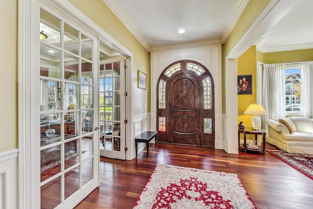 foyer with dark wood-type flooring, french doors, and ornamental molding