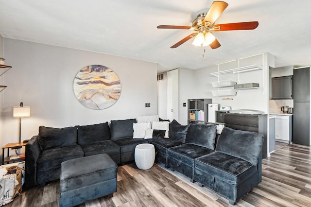 living room featuring ceiling fan and wood-type flooring