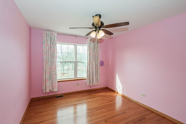 empty room featuring ceiling fan and light hardwood / wood-style floors