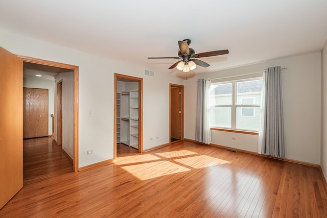 empty room featuring ceiling fan and light wood-type flooring