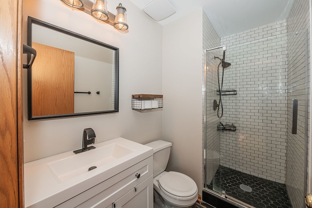 bathroom with vanity, toilet, and an enclosed shower