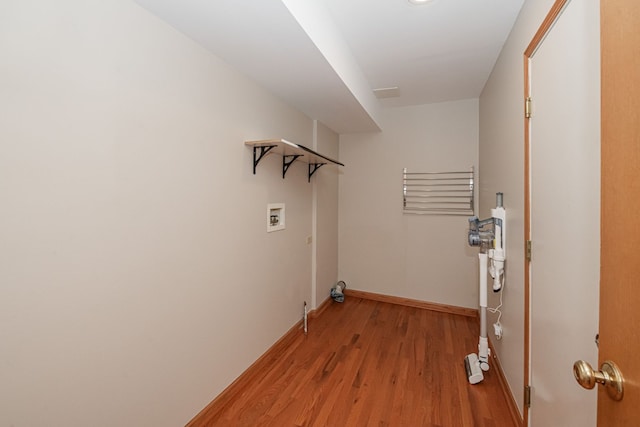 clothes washing area featuring washer hookup and light wood-type flooring