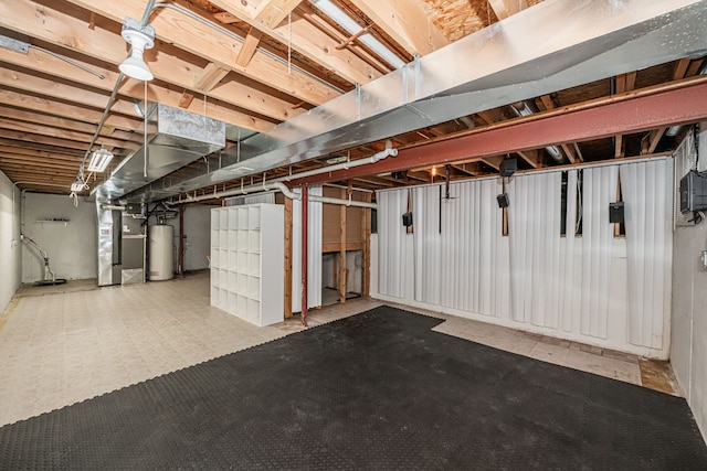 basement with water heater and heating unit