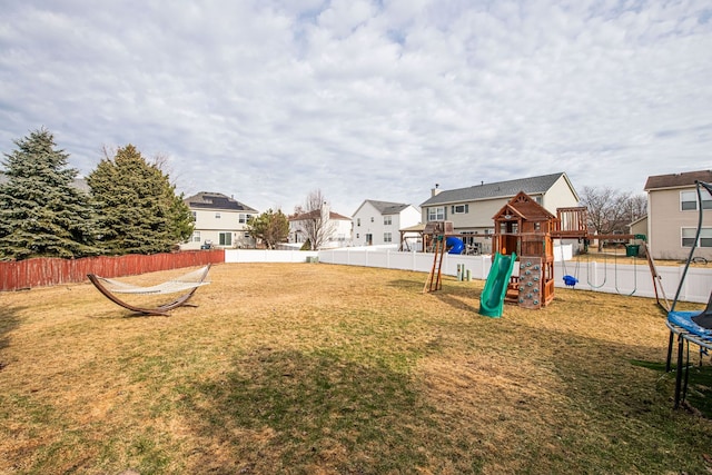 view of yard featuring a playground and a trampoline