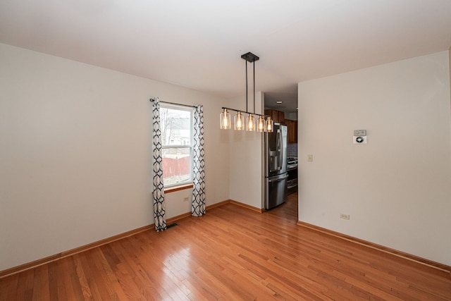 unfurnished dining area featuring light hardwood / wood-style flooring