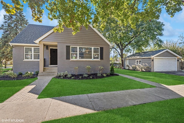 view of front facade featuring a front lawn, a garage, and an outdoor structure