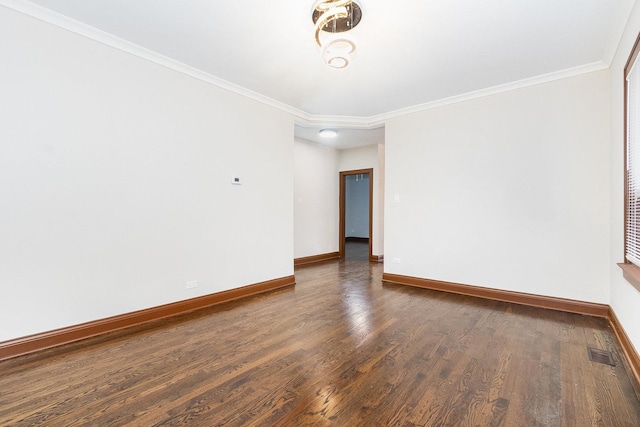 unfurnished room featuring ornamental molding and dark wood-type flooring