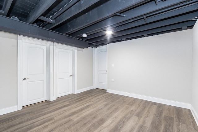 basement with hardwood / wood-style flooring