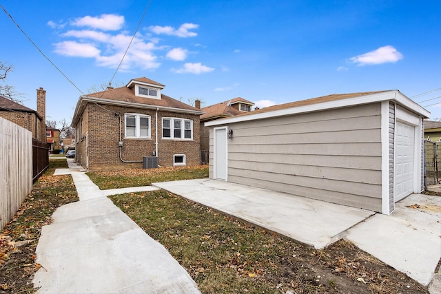 back of property with a garage and an outbuilding