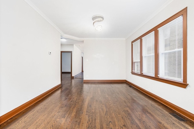 empty room with crown molding and dark hardwood / wood-style flooring