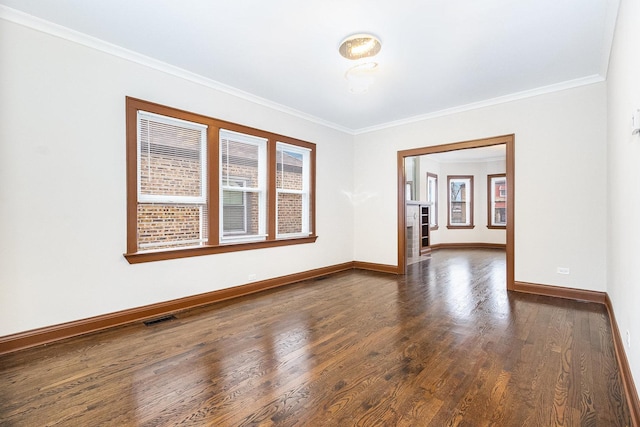 spare room with dark wood-type flooring and crown molding