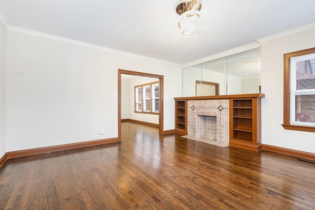 unfurnished living room featuring ornamental molding, dark hardwood / wood-style flooring, and a tile fireplace