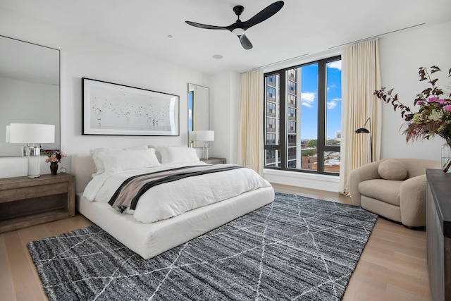 bedroom featuring ceiling fan and light hardwood / wood-style floors