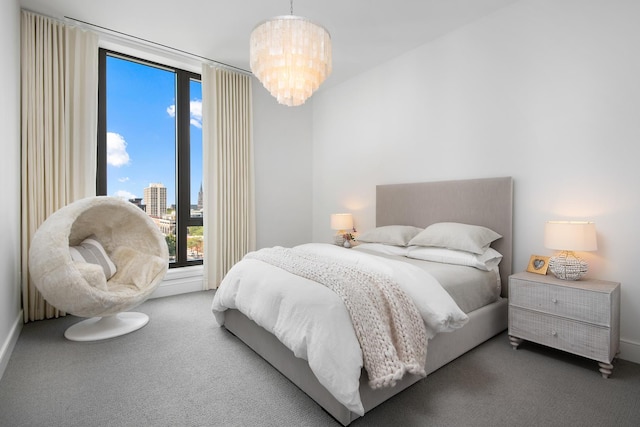 bedroom with carpet floors and a notable chandelier