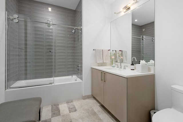 full bathroom with toilet, vanity, and bath / shower combo with glass door