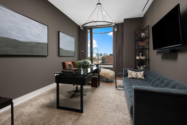 carpeted office featuring a chandelier