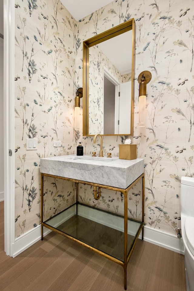 bathroom with hardwood / wood-style flooring, vanity, and toilet