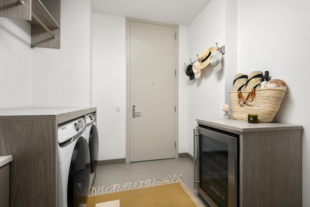 washroom featuring light tile patterned flooring, wine cooler, and washer and clothes dryer