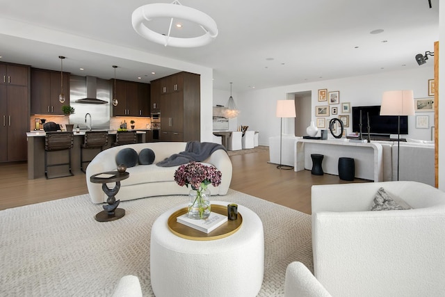 living room with sink and light hardwood / wood-style floors