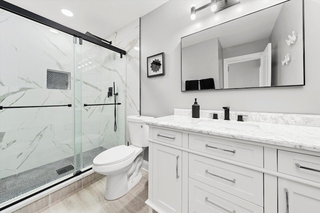 bathroom with walk in shower, vanity, and toilet