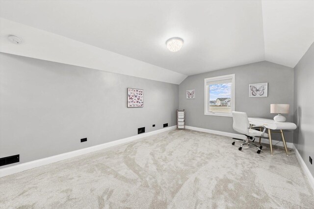 office space featuring vaulted ceiling and carpet flooring