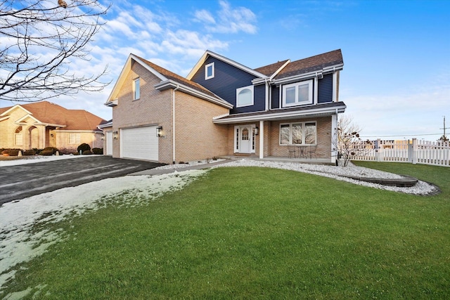 front facade featuring a garage and a front lawn