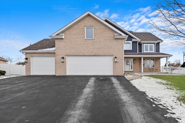 view of property featuring a garage and covered porch