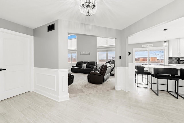 living room featuring a chandelier and light tile patterned flooring