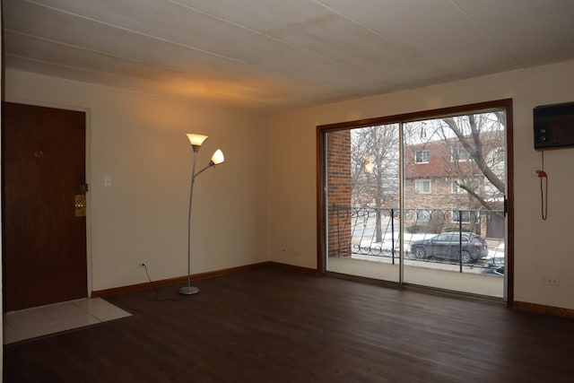 empty room with dark hardwood / wood-style flooring